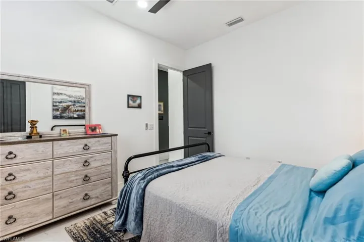 Bedroom with ceiling fan and visible vents