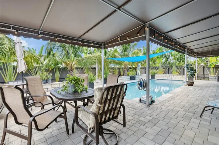 View of swimming pool with a patio, a fenced in pool, a fenced backyard, and outdoor dining space