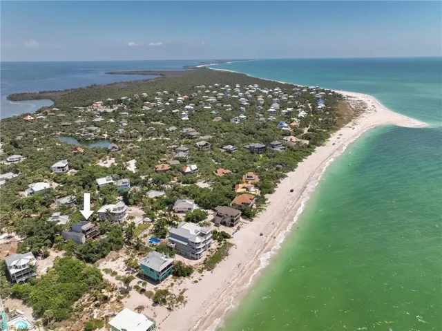 Aerial view featuring a beach view and a water view
