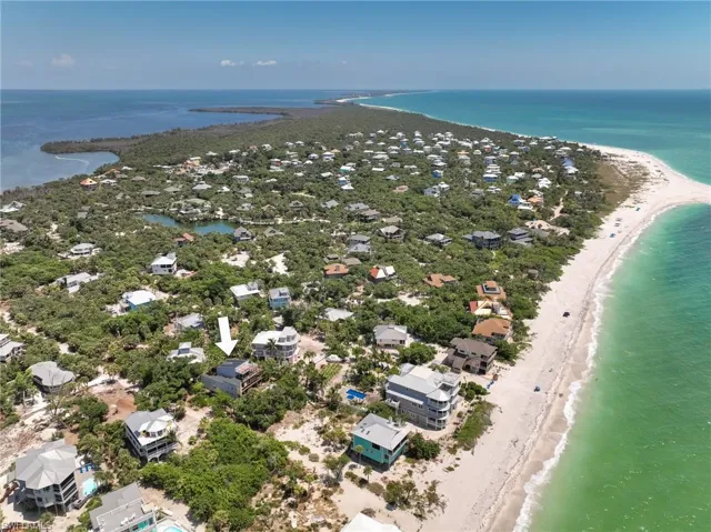 Birds eye view of property featuring a view of the beach and a water view