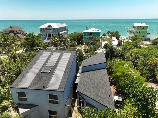 Birds eye view of property with a water view