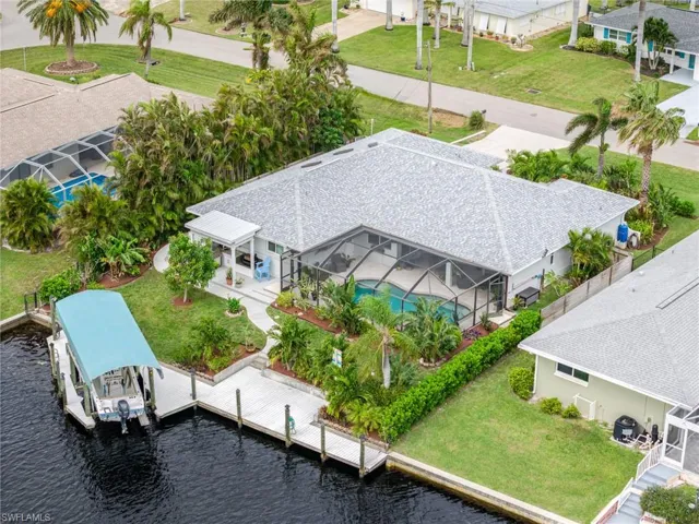 View from above of property with a pool area and a nearby body of water