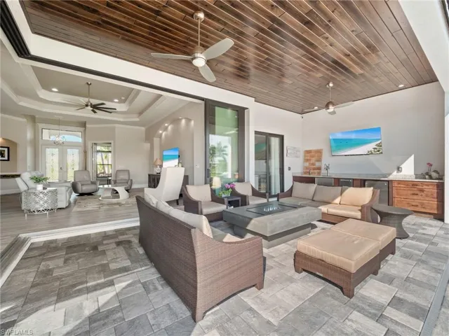 View of patio with ceiling fan, an outdoor kitchen, and an outdoor living space