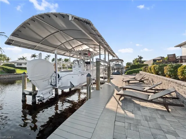 View of dock with a water view and boat lift
