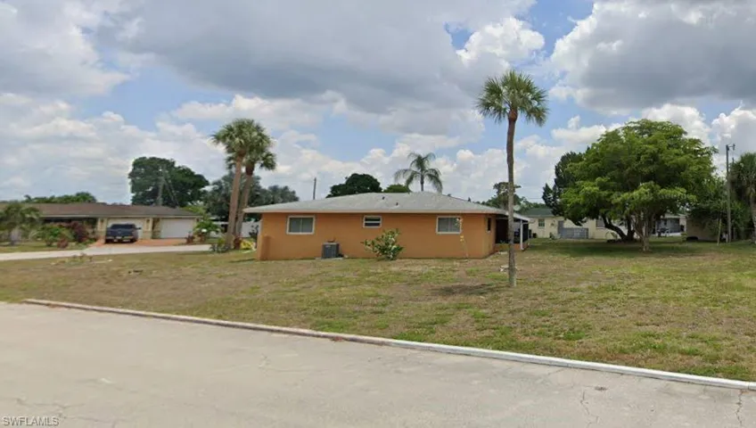 View of side of property featuring a yard