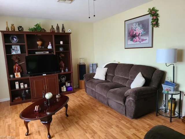 Living area with light wood-type flooring and ceiling fan