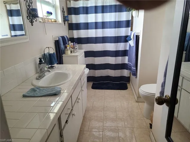 Full bathroom featuring toilet and vanity