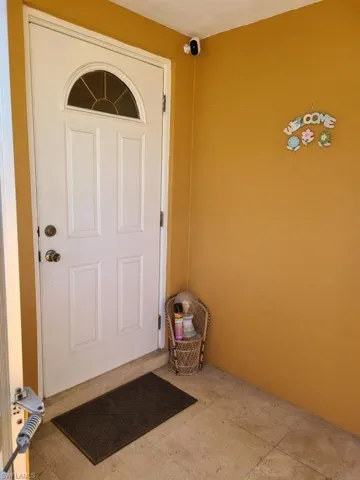 Doorway to property featuring a surveillance system