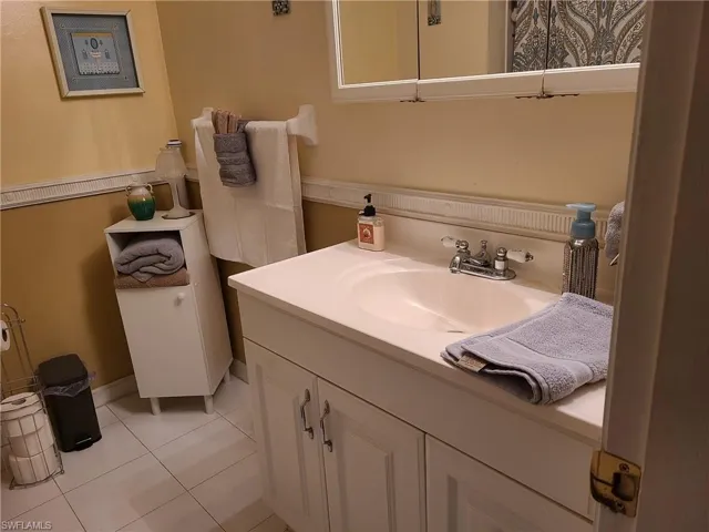 Bathroom with vanity and tile patterned flooring
