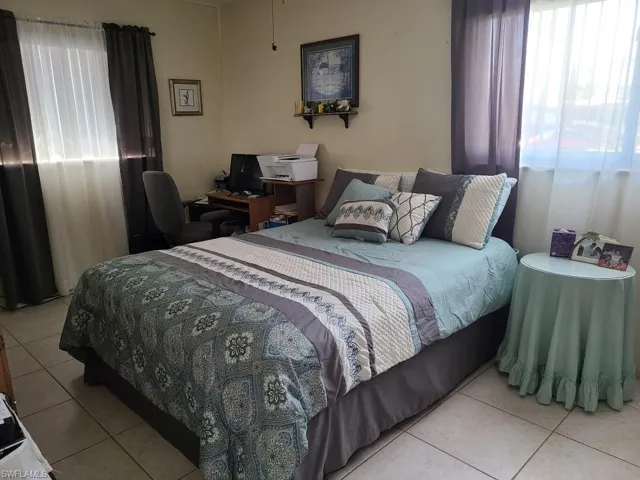 Bedroom with light tile patterned floors