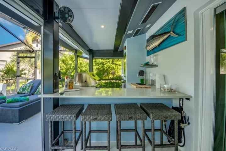Kitchen with a kitchen bar, recessed lighting, and open shelves