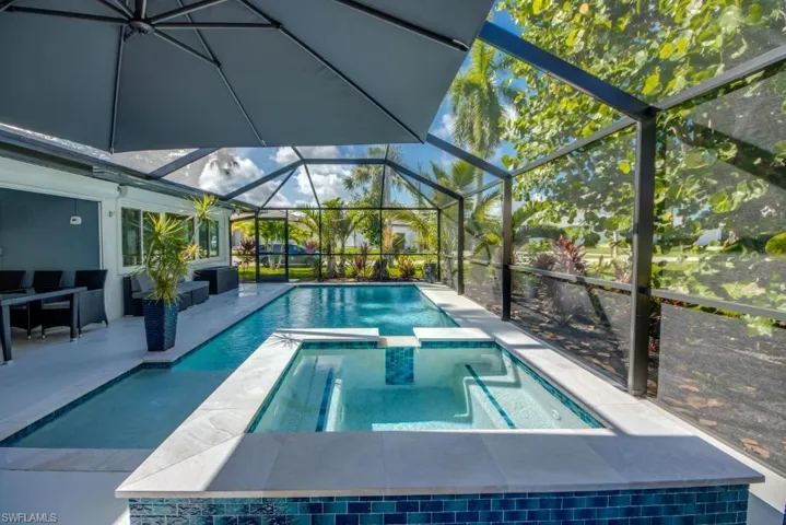 Integrated pool / spa featuring a patio, a sunroom, and a lanai
