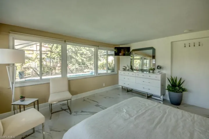 Bedroom with baseboards and light marble finish floors