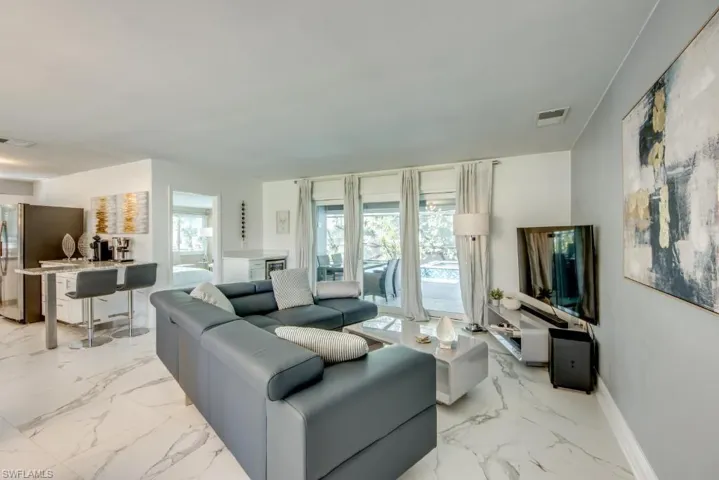 Living area featuring light marble finish floors
