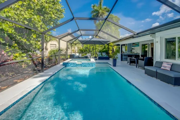 Integrated pool / hot tub featuring an outdoor living space, a sunroom, a patio, and a lanai