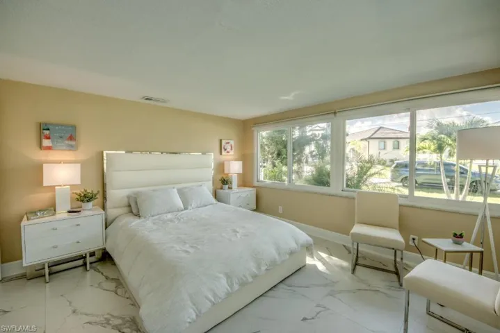 Bedroom featuring baseboards and marble finish floors