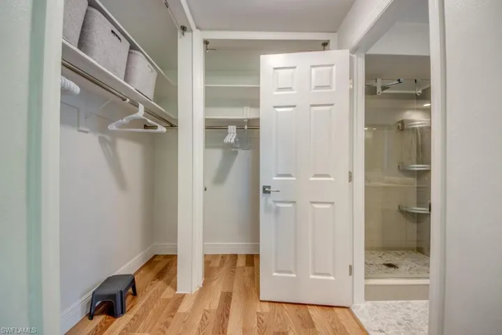 Walk in closet featuring light wood-style flooring