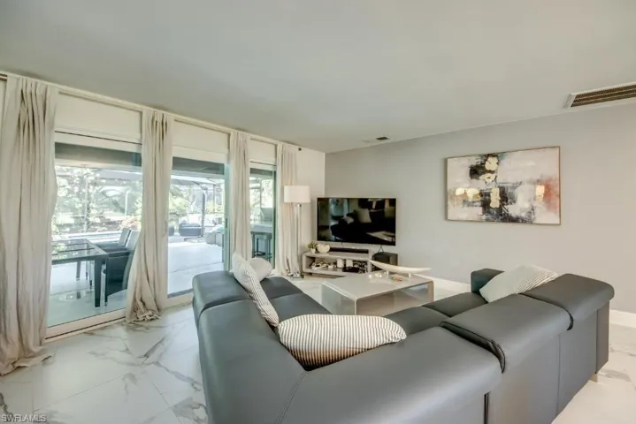 Living area featuring light marble finish floors
