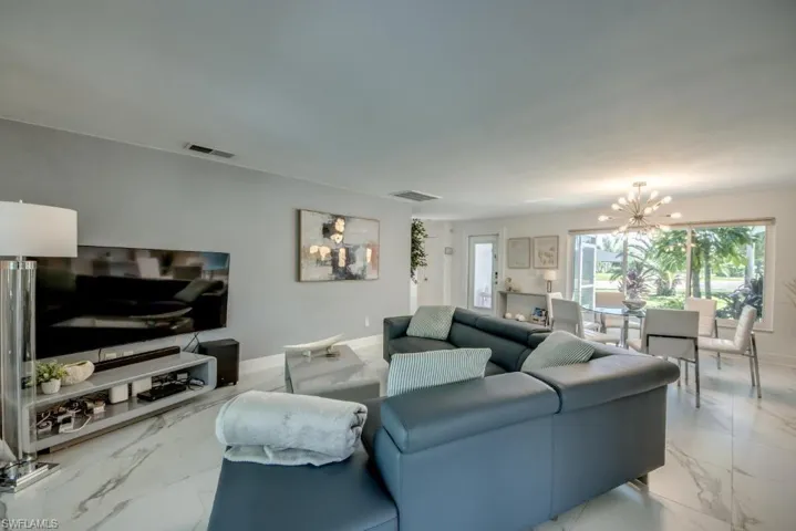 Living room with marble look tiles and hanging lights