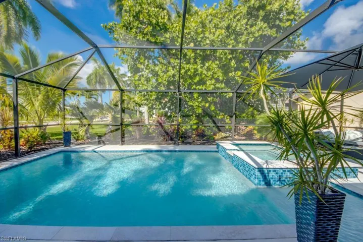 Relaxing pool / spa with a sunroom and a lanai