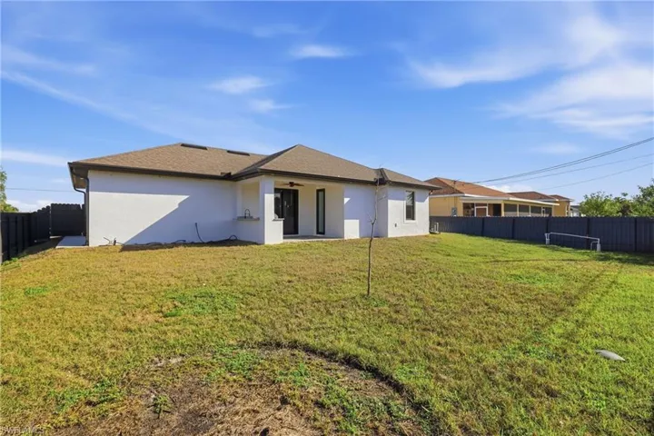 Back of property with a fenced backyard, stucco siding, a patio, and ceiling fan