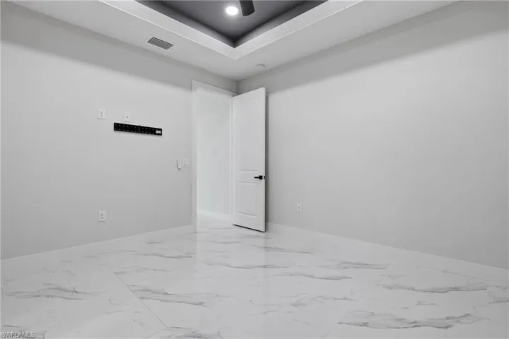 Empty room featuring baseboards and light marble finish flooring