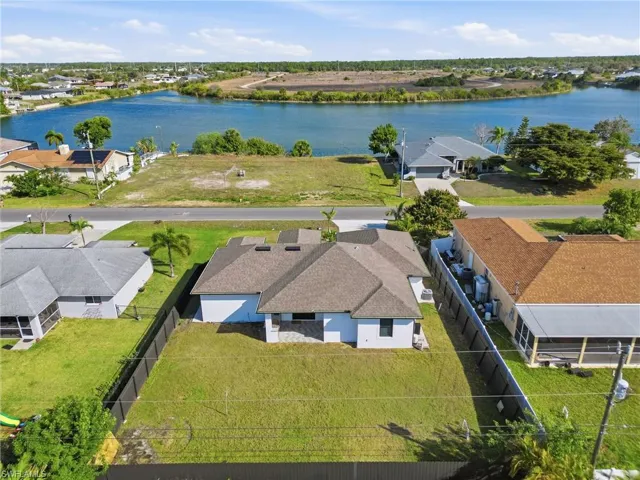 Aerial perspective of suburban area with a large body of water
