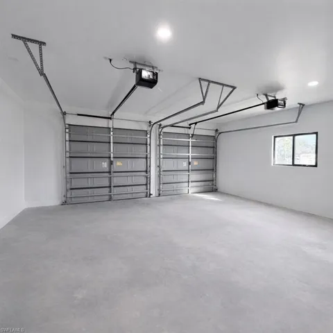 Garage featuring recessed lighting and a garage door opener