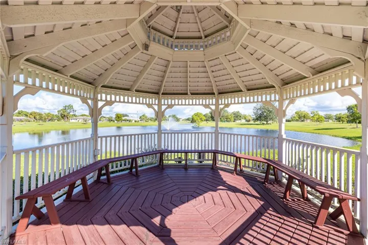 Wooden deck with a gazebo and a water view