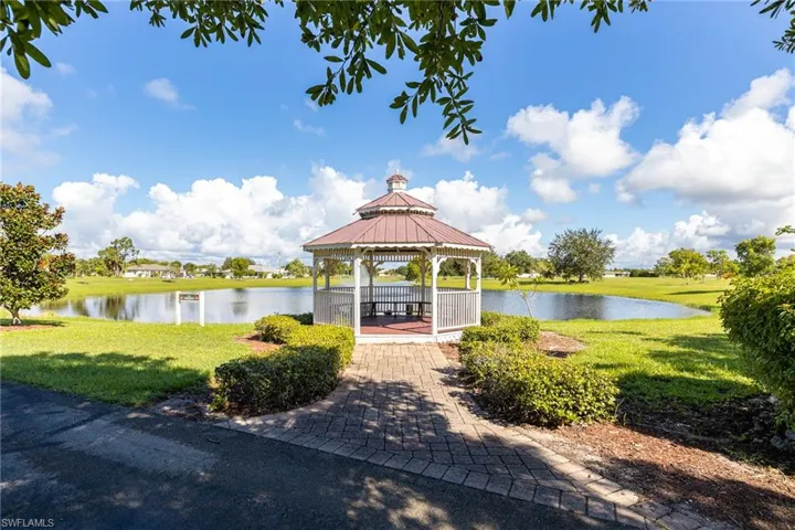 View of property's community featuring a gazebo, a water view, and a yard