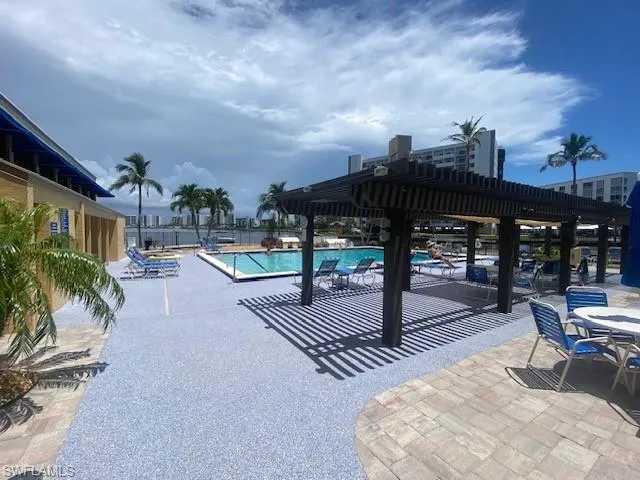 Community pool with a patio and a pergola