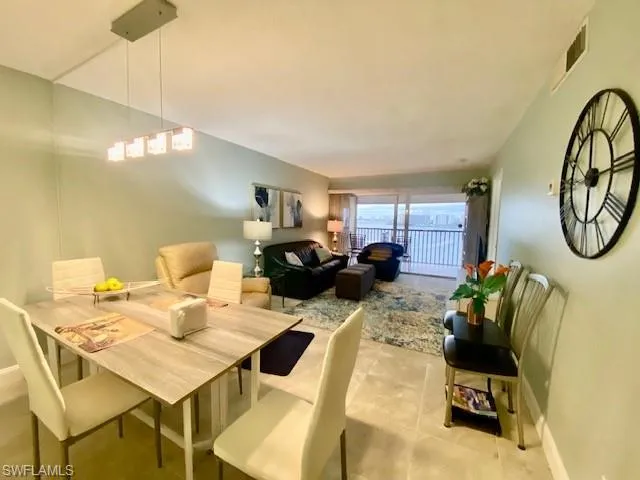 Tiled dining space featuring baseboards