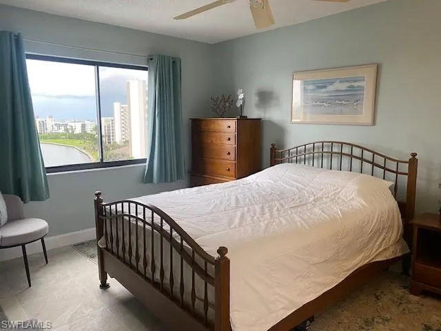 Bedroom featuring ceiling fan and a textured ceiling
