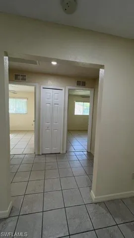 Light gray square tile flooring in a prominent hallway