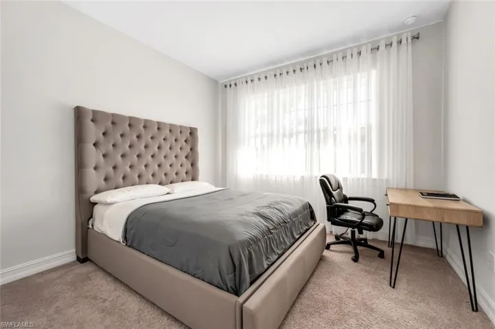 Carpeted bedroom with baseboards