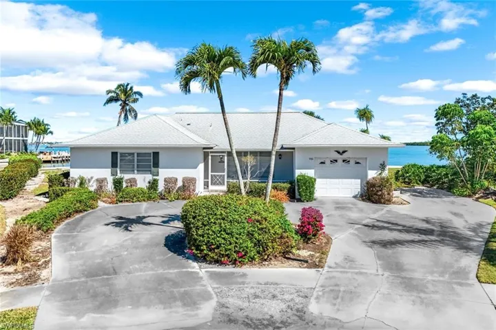 Single story home featuring an attached garage, driveway, and stucco siding