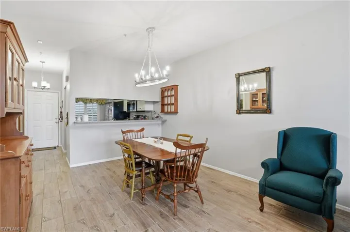 Dining area featuring light wood-type flooring and suspended lighting