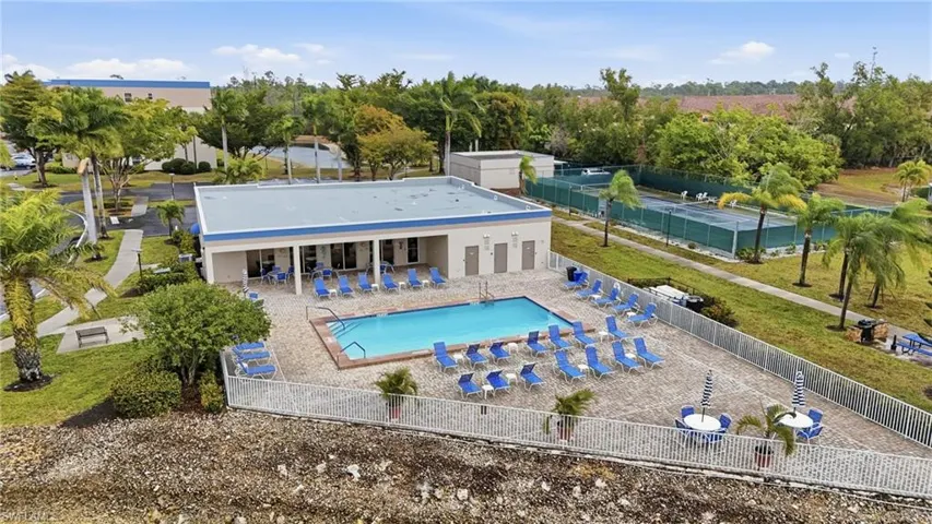 Back of house with a patio and a community pool