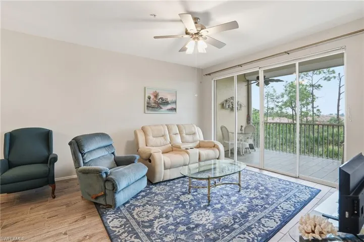 Living area featuring a ceiling fan and light wood finished floors
