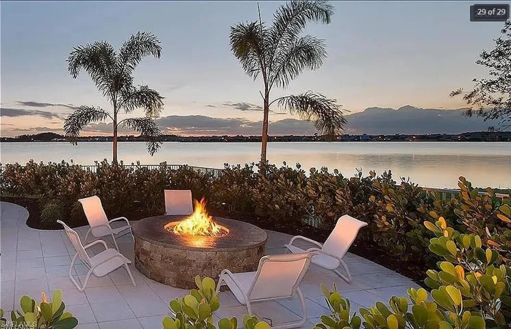 Cozy outdoor fire pit area with comfortable seating and picturesque lake views.