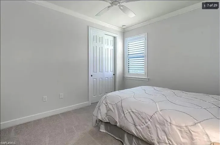 Comfortable guest bedroom with natural light and ample closet space.