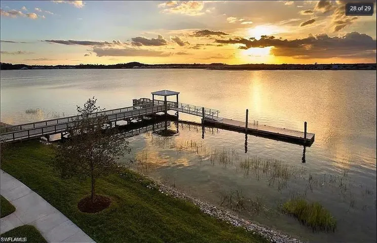 Tranquil lakeside dock offering stunning sunset views and waterfront relaxation.
