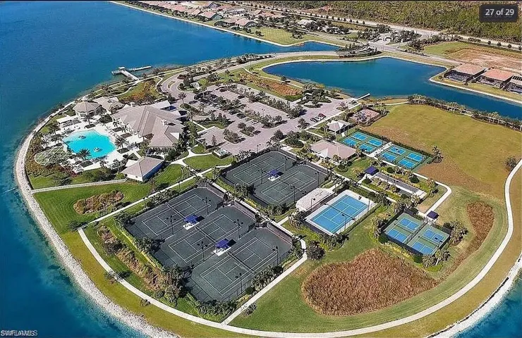 Sweeping community view featuring tennis courts, pools, and waterfront living.