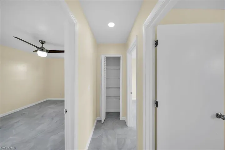 Hallway featuring baseboards and recessed lighting