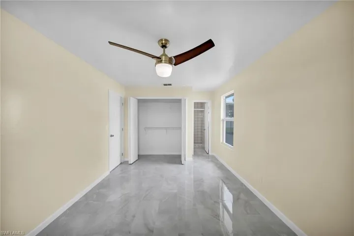 Corridor with marble look tiles and baseboards