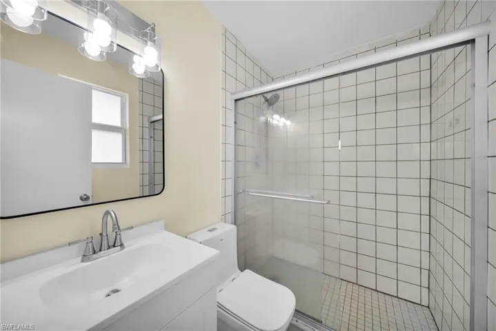 Bathroom featuring a stall shower and vanity