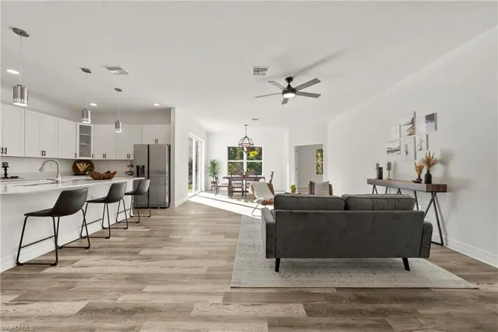 Living room with ceiling fan and LVP flooring