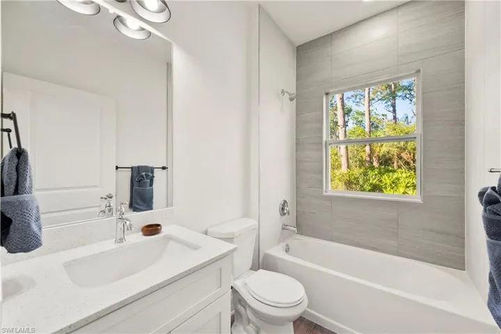 Full bathroom featuring vanity, toilet, and tiled shower / bath