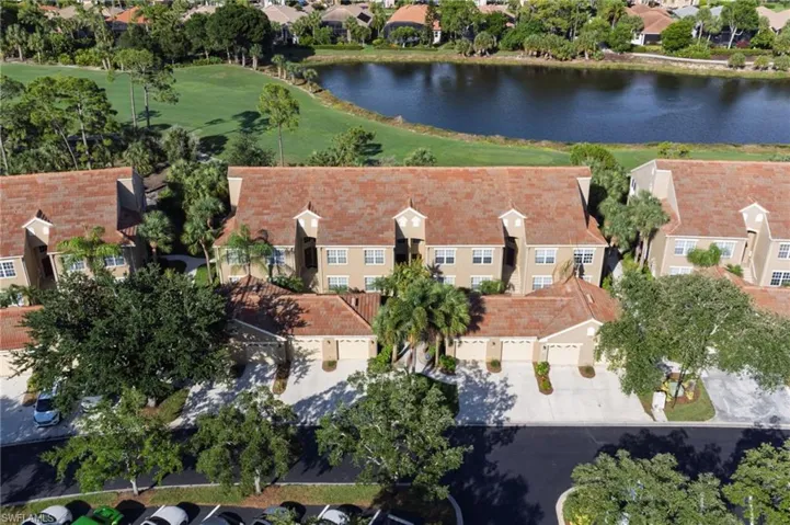 Multi-story residential buildings with red tile roofs and tan exteriors