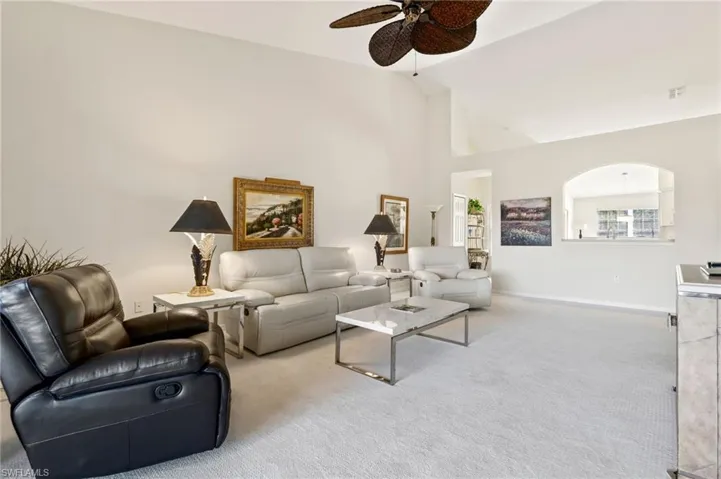 Spacious interior with vaulted ceilings and light-toned carpeting
